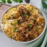 Lamb biryani in white shallow bowl.