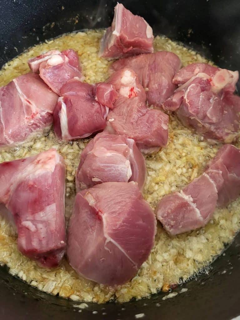 raw lamb meat on top of chopped onion,