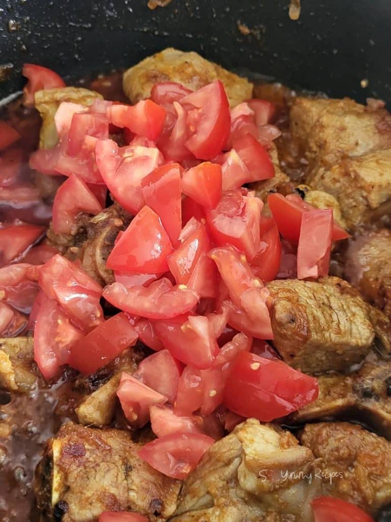 chopped tomatoes over the lamb meat.