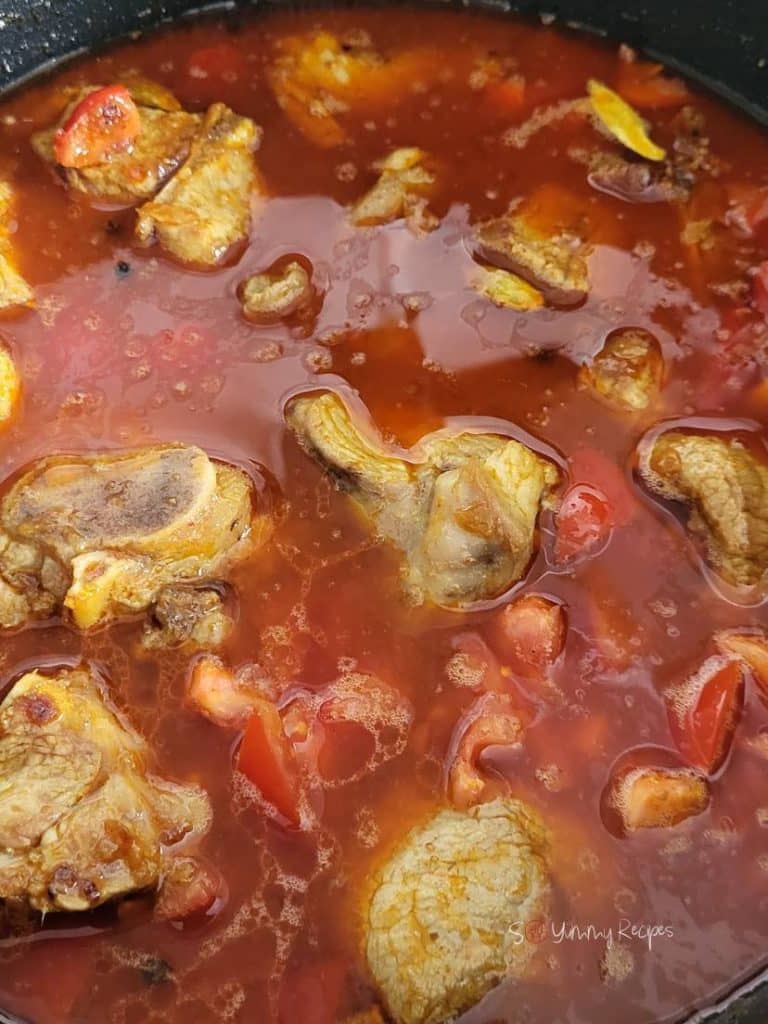 meat in spiced water and chopped tomatoes.