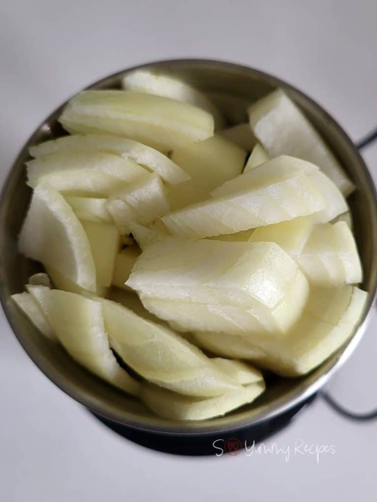 Onions in a food chopper.
