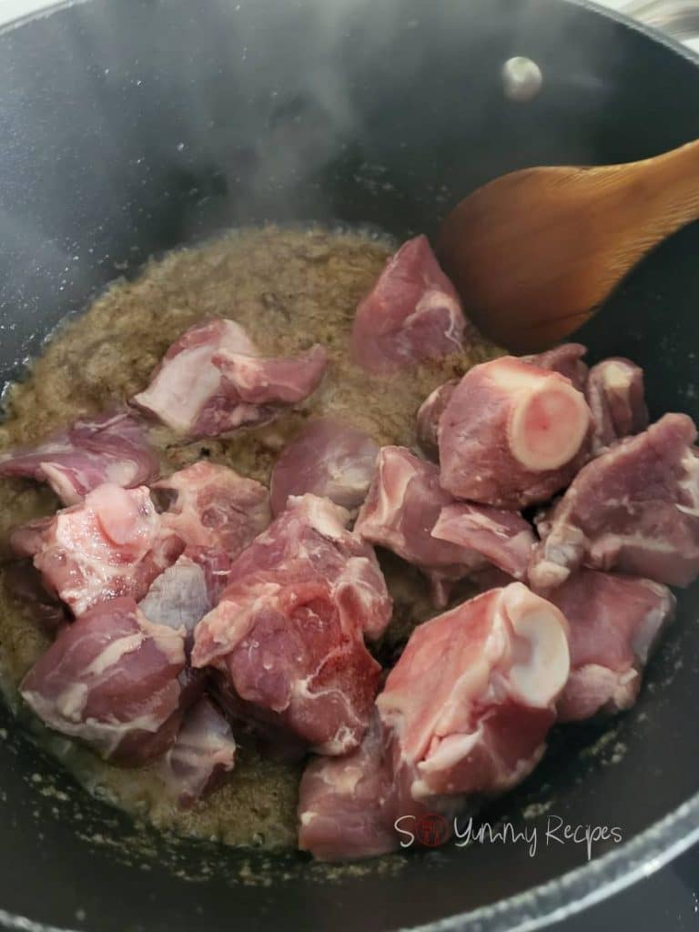 Lamb pieces added to the spice mixture.