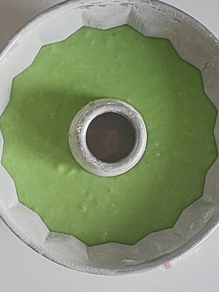 green cake batter in a cake bundt tin.
