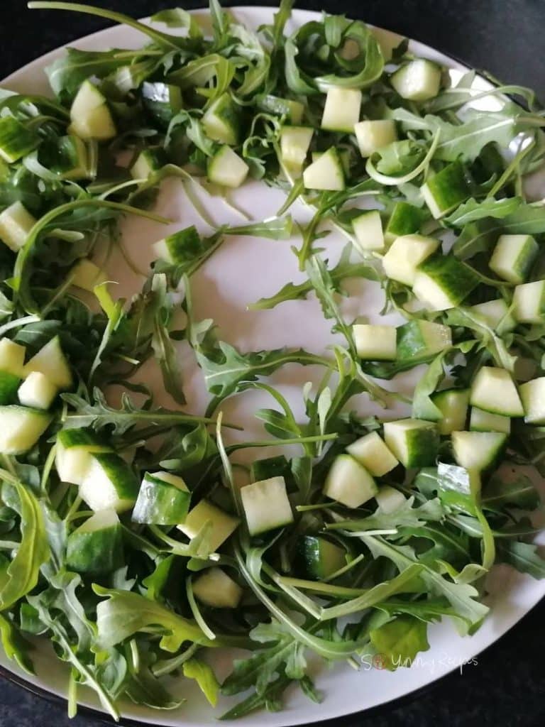Arugula leaves and chopped apples.