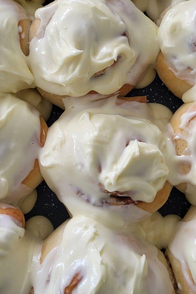 Cinnamon rolls covered with cream cheese frosting.