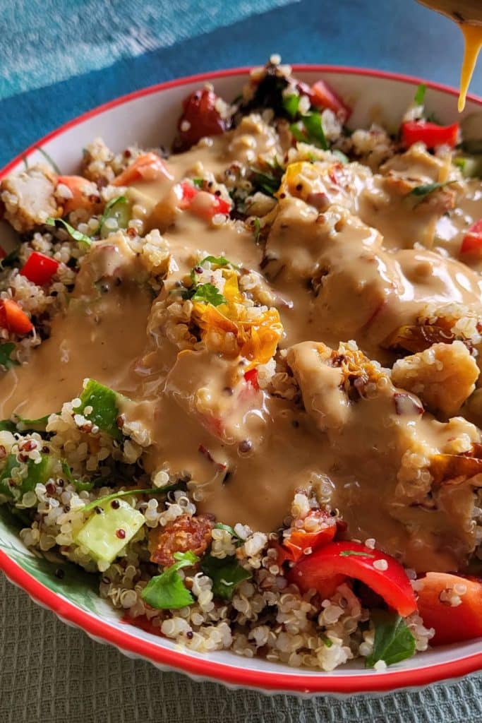 Quinoa salad covered with tahini dressing.