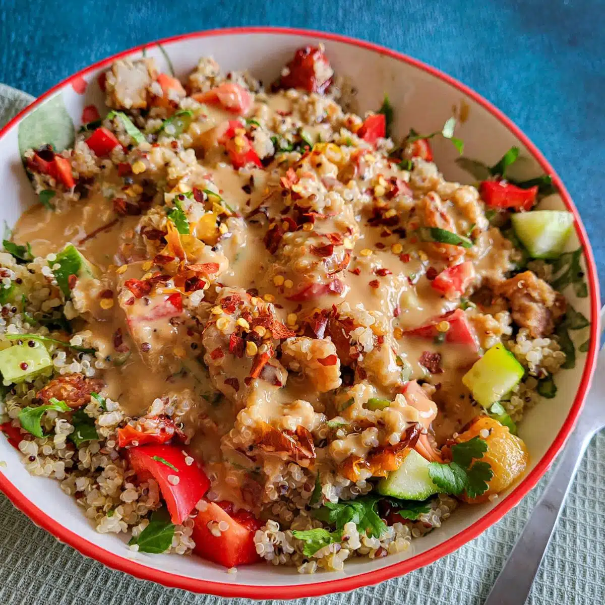 Roasted tomato quinoa salad in a round serving bowl.