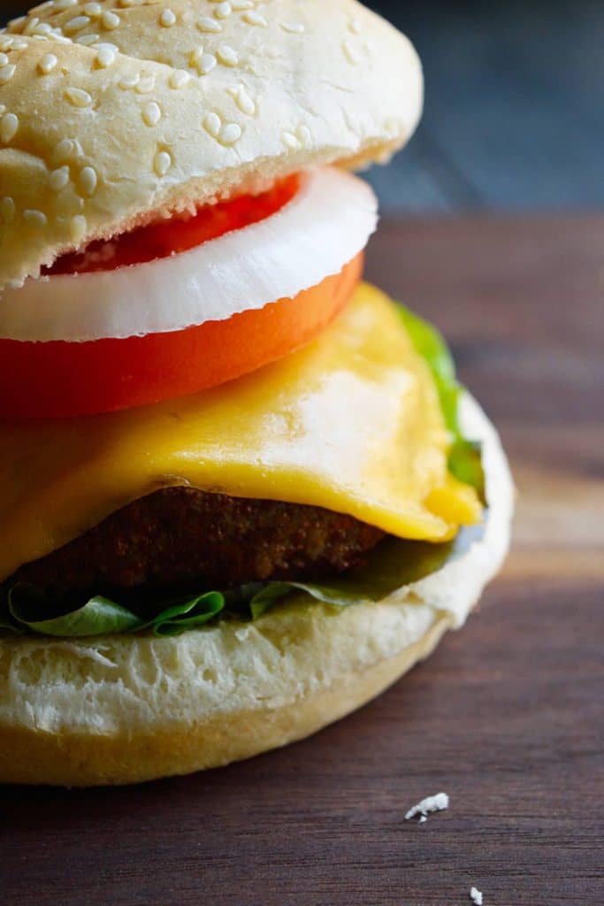Air fryer turkey burger in bun with salad and cheese.