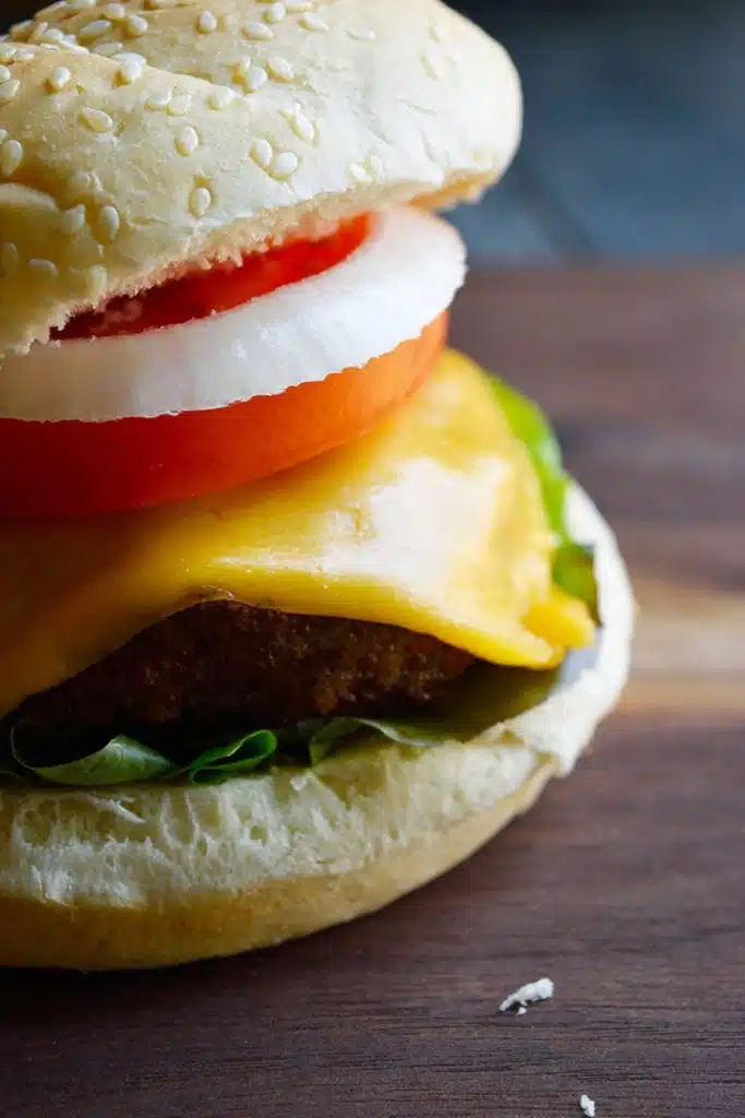Air fryer turkey burger in bun with salad and cheese.
