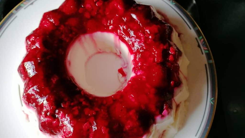 Agar agar milk pudding with raspberries.