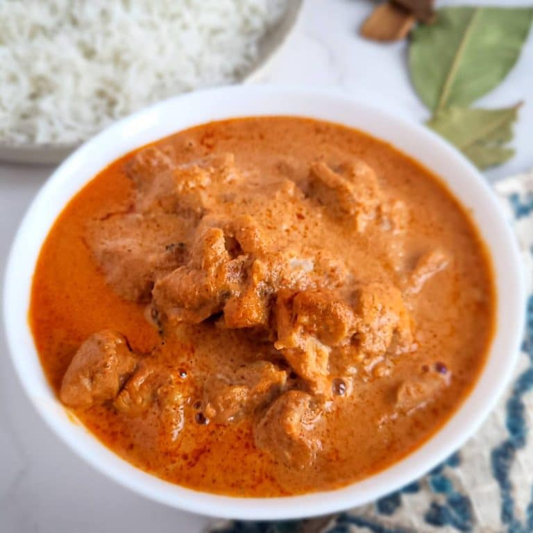 Chicken korma in white bowl.