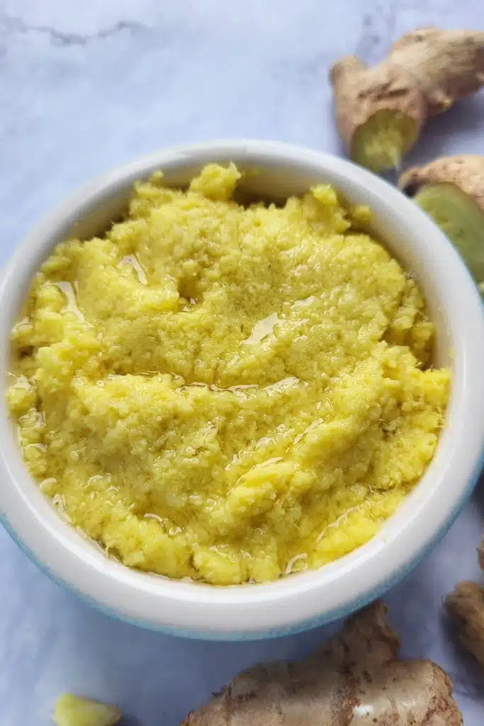 Freshly ground ginger in a small white bowl. 