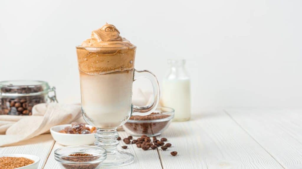 Cold milk, Dalgona coffee, coffee beans, and a bowl of instant espresso.