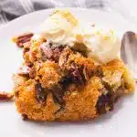 A portion of pecan cobbler with scoops of ice cream.