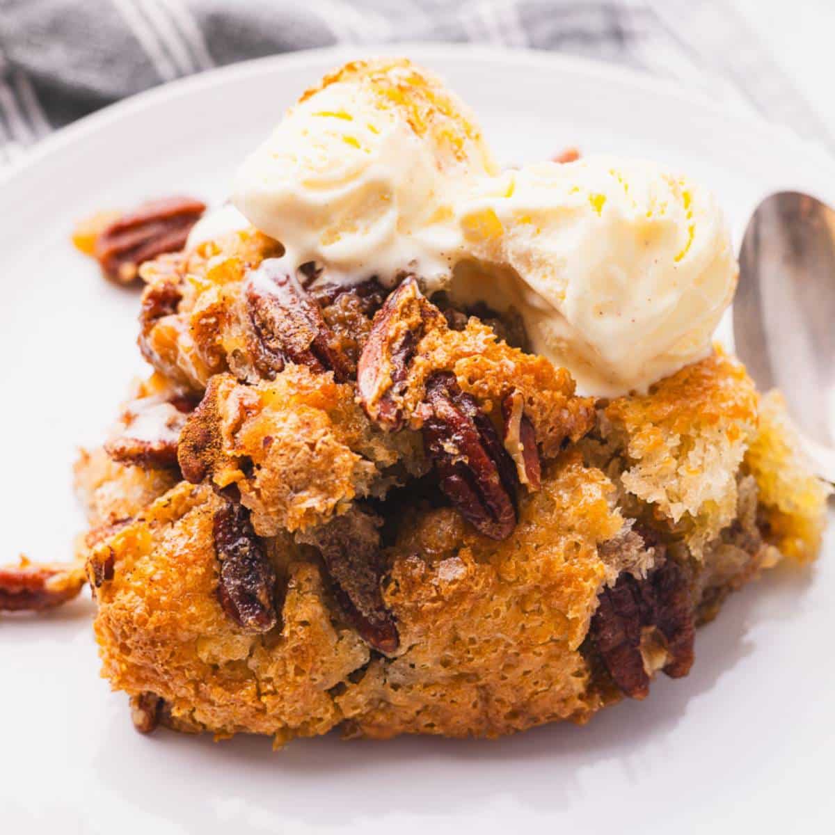 A portion of pecan cobbler with scoops of ice cream.