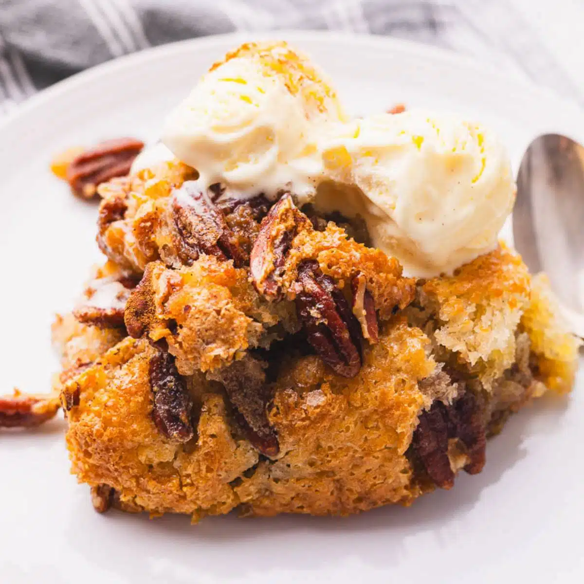 A portion of pecan cobbler with scoops of ice cream.