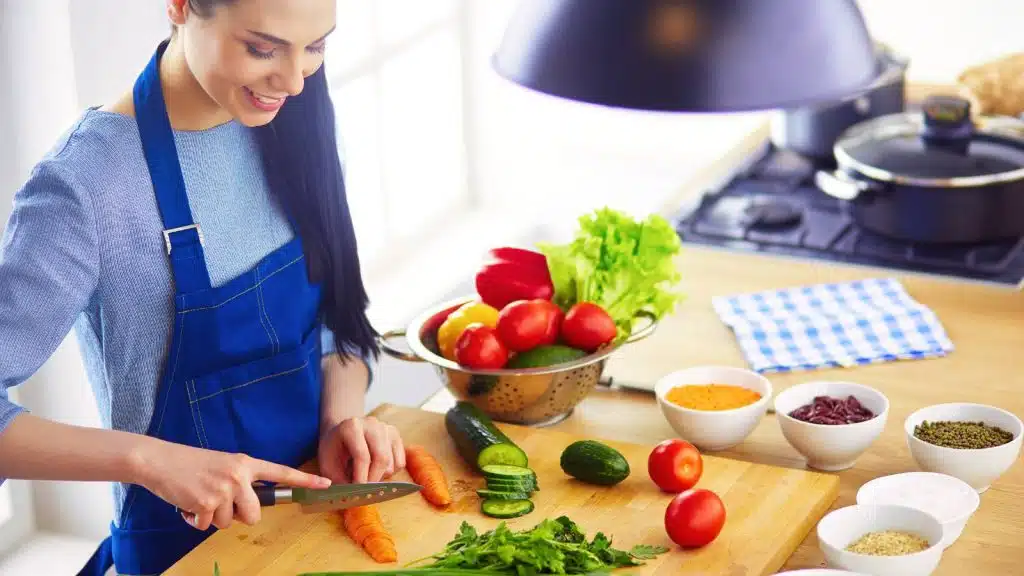 A woman cutting vegetables.
