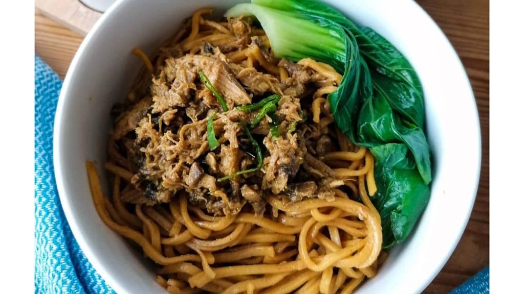 Mie Ayam garnished with bok choi.