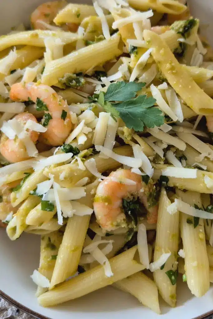 Pasta with shrimp and shredded cheese.