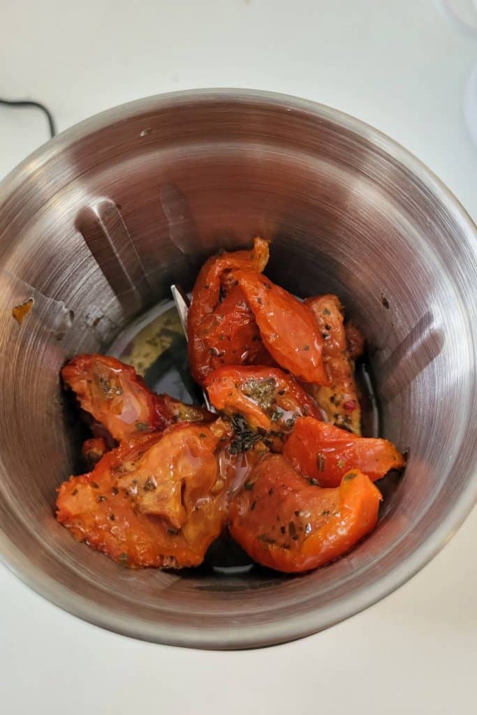 Sun dried tomatoes in a food chopper.