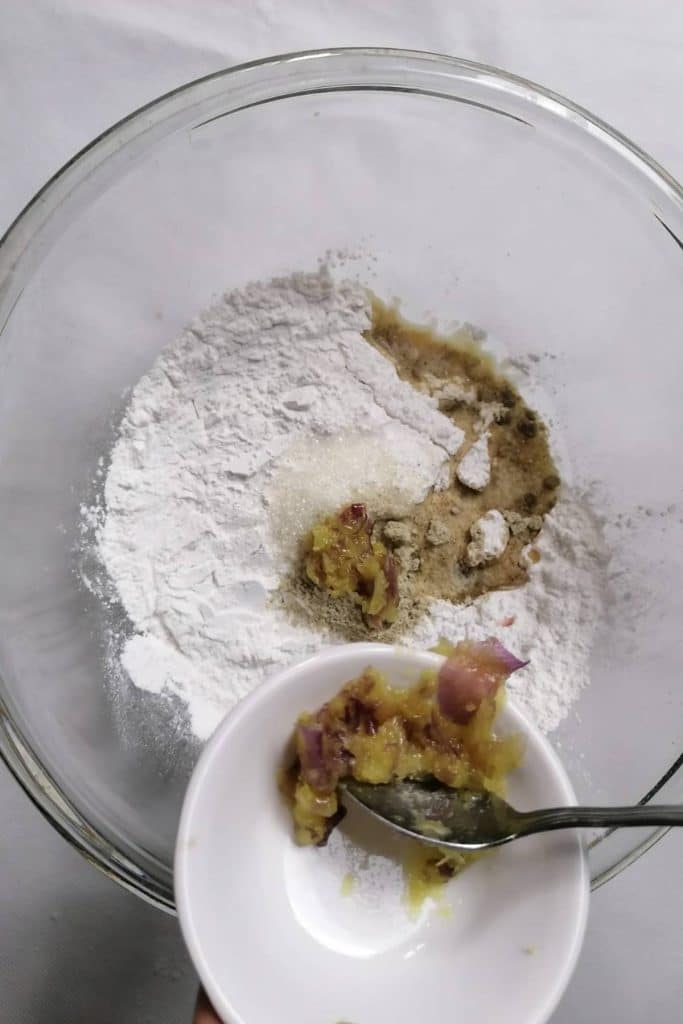 Flour, spices, and fried onion in a mixing bowl.