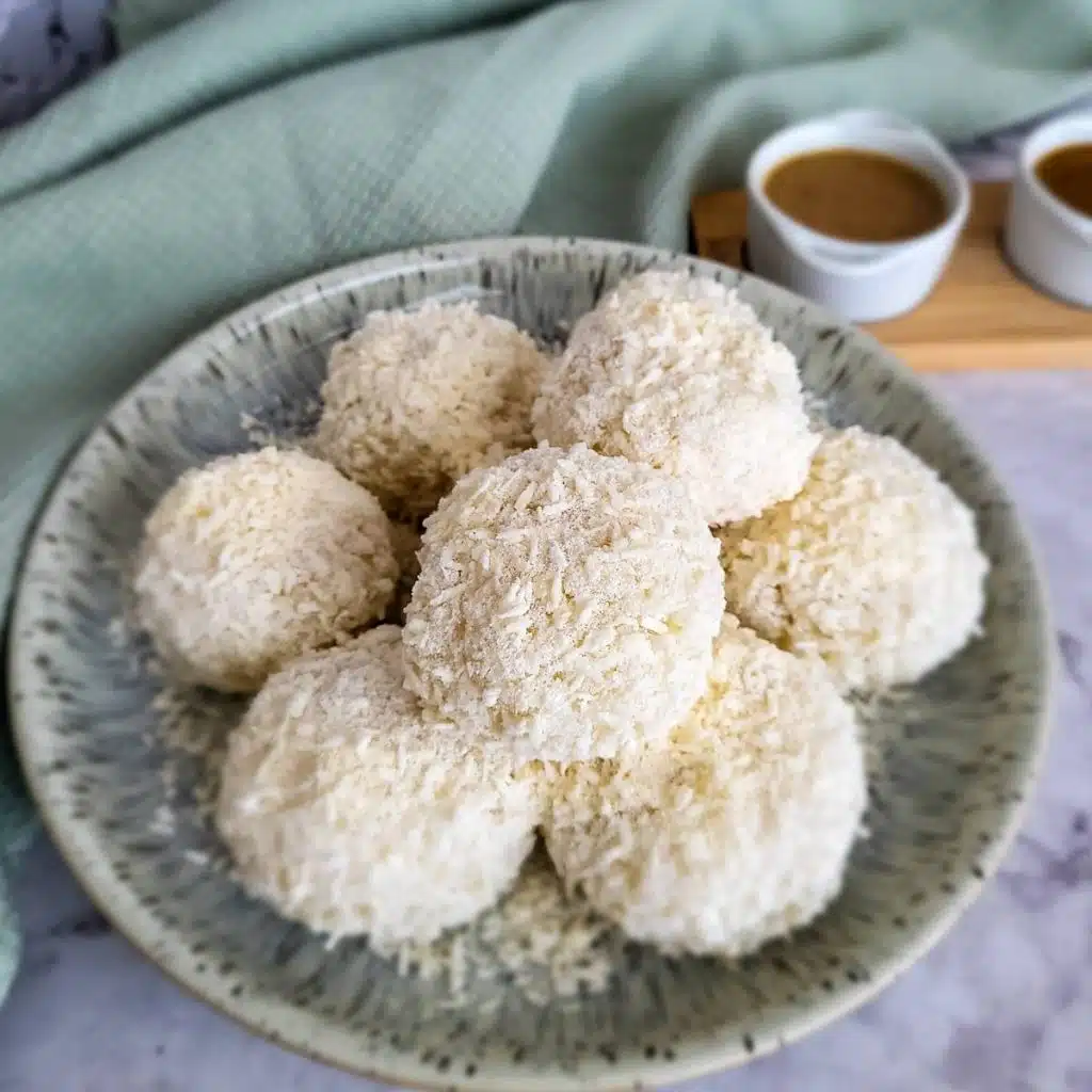 A stack of sticky sweet rice balls, ketan putih, on a plate.