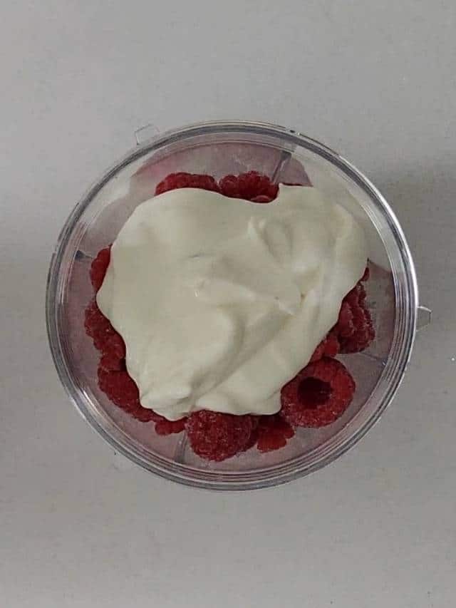 Yogurt over raspberries.