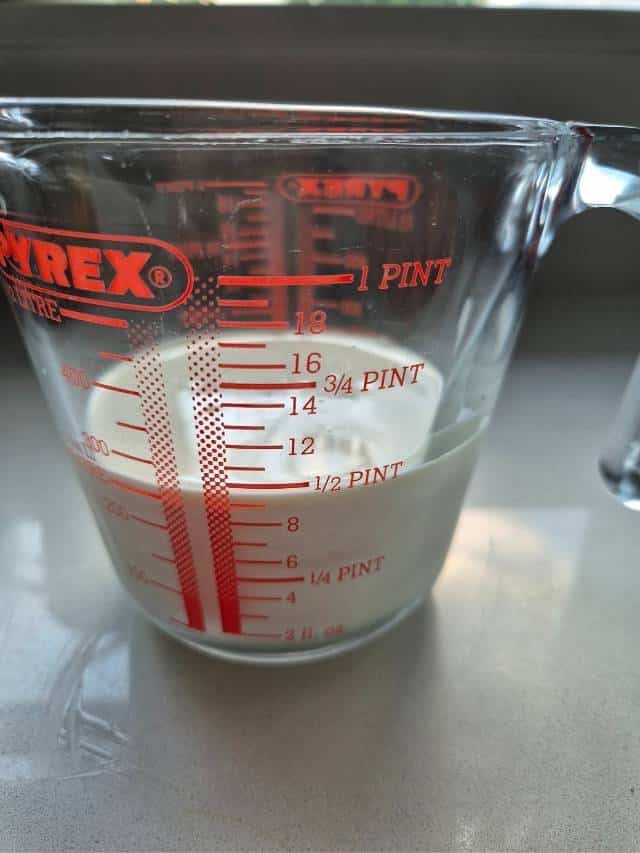 Milk and cream in a measuring jug.