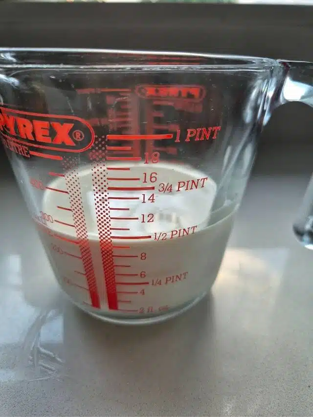 Milk and cream in a measuring jug.