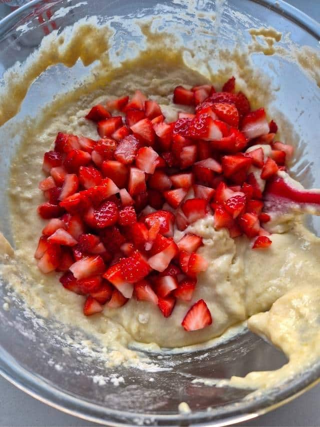 Chopped strawberries in muffin batter.