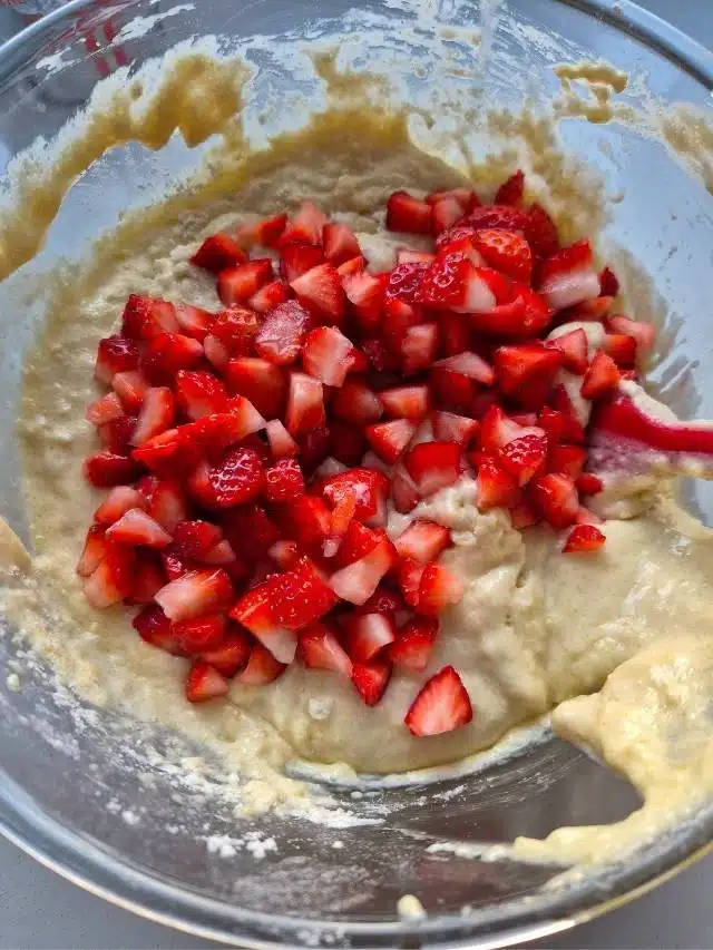 Chopped strawberries in muffin batter.