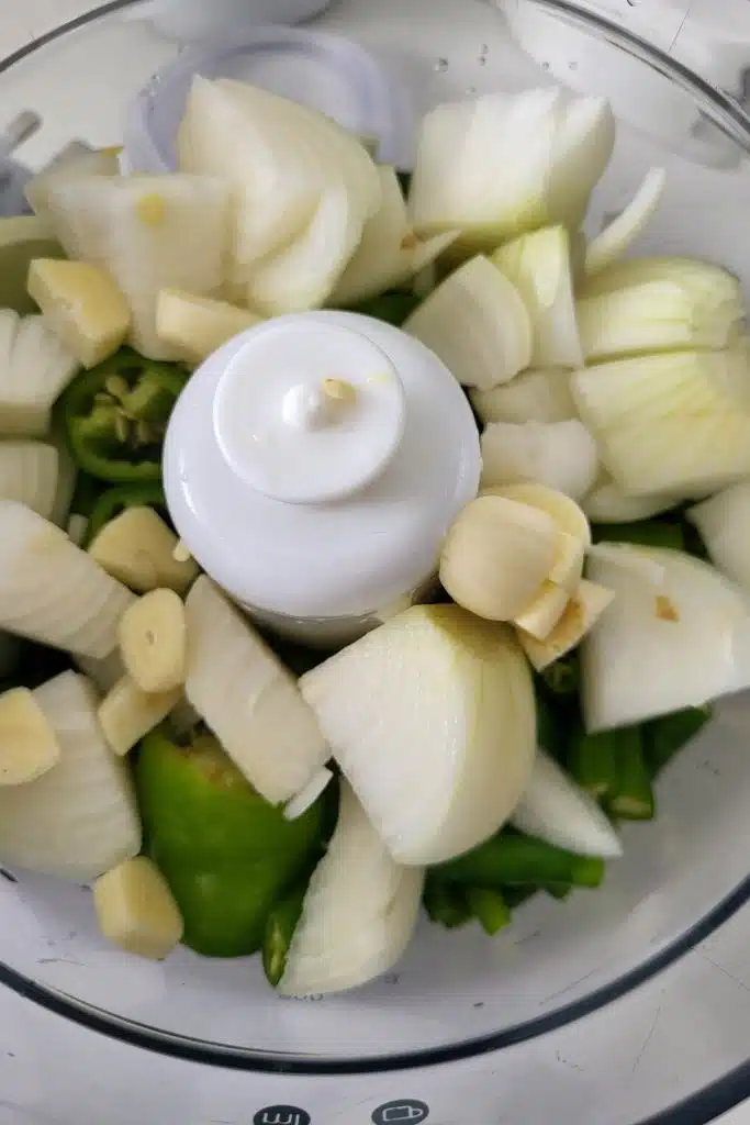 onion, garlic, and chili in a food chopper. 