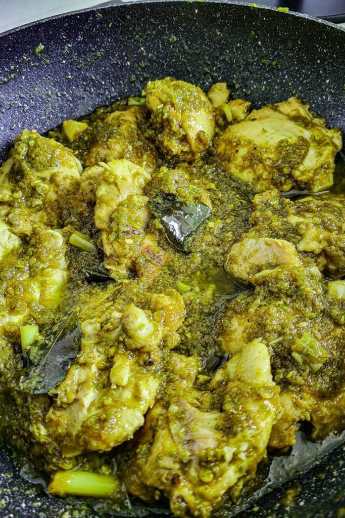 Indonesian ayam sambal hijau - chicken in green sambal in a frying pan.