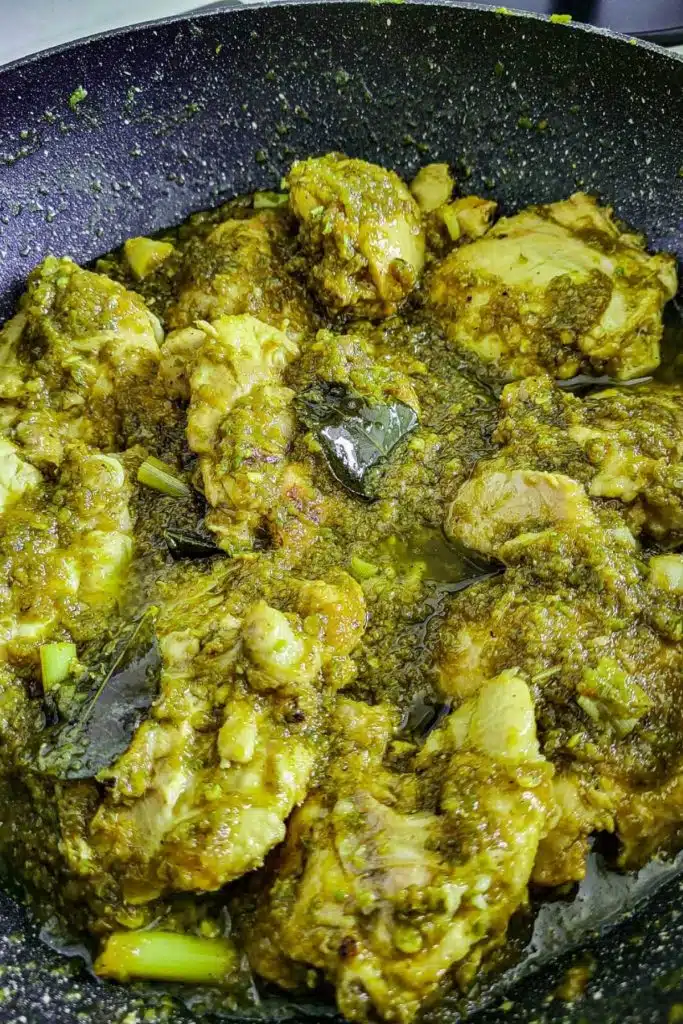 Indonesian ayam sambal hijau - chicken in green sambal in a frying pan.
