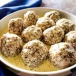Beef kofta meatballs with creamy sauce on a serving plate.