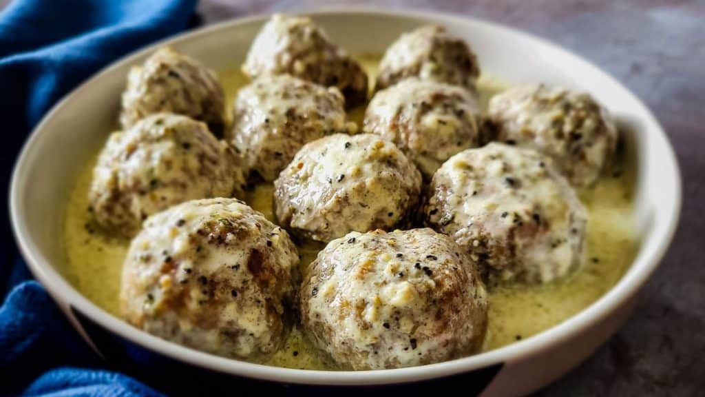 Beef kofta meatballs in creamy pan gravy, horizontal shot.