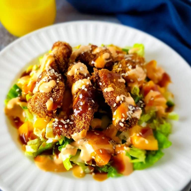 Chicken katsu salad in white bowl.