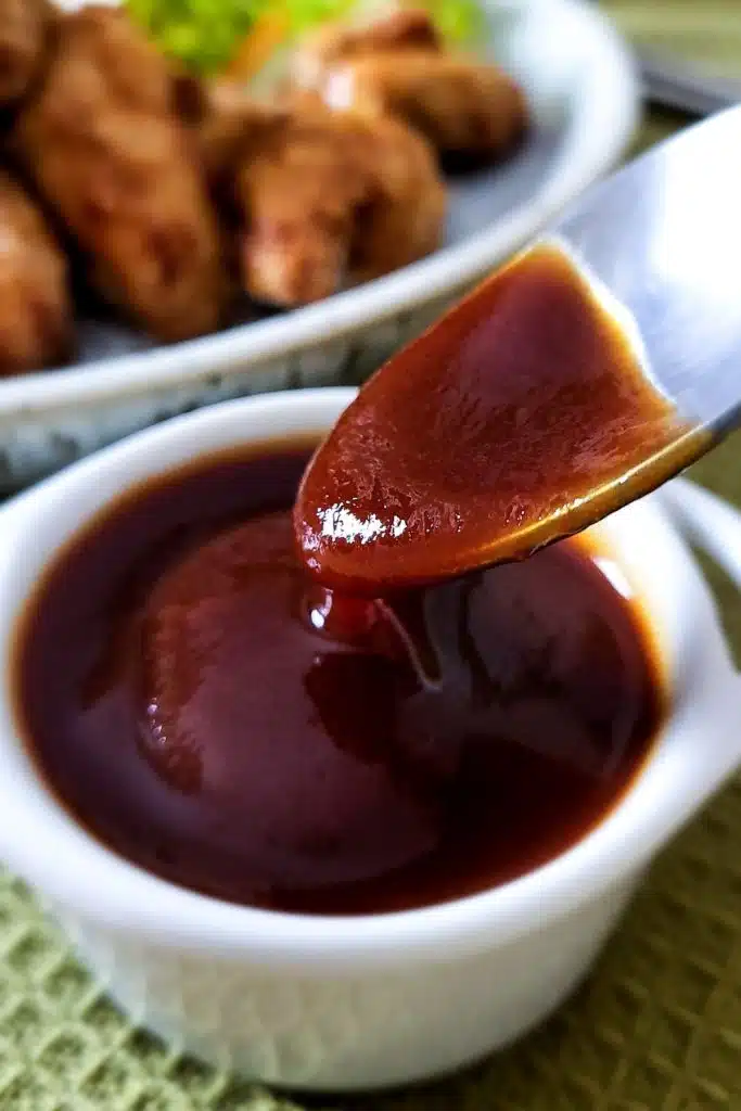 Spoon over homemade teriyaki sauce in a small white bowl.